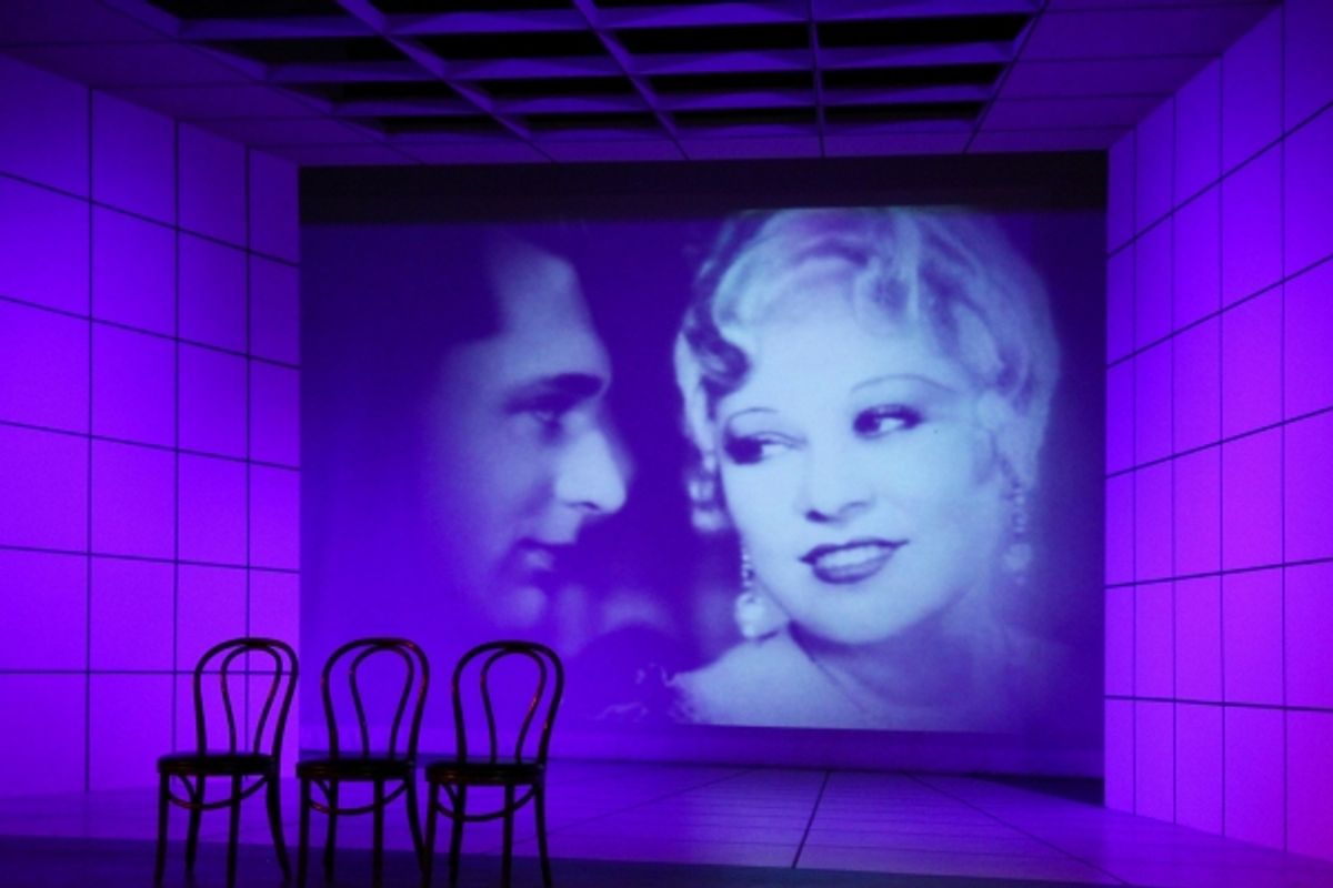 A scene from 'Dirty Blonde' featuring a photo of Cary Grant and Mae West from the Paramount film 'I'm No Angel.' at 